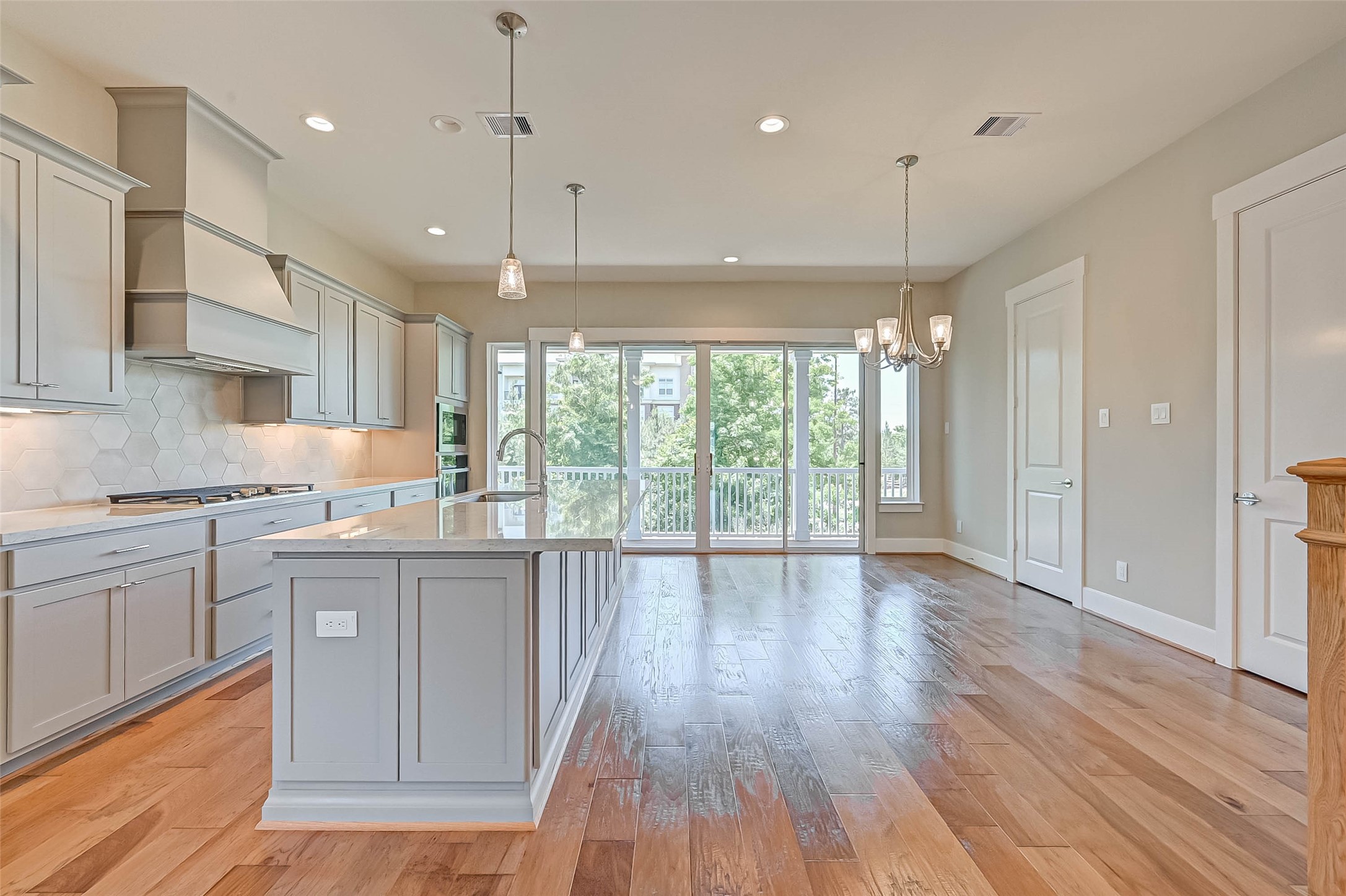 67 Thorpe Lane Spring, TX 77389 - Photo 17 of 27 a kitchen with stainless steel appliances granite countertop wooden floors sink and cabinets