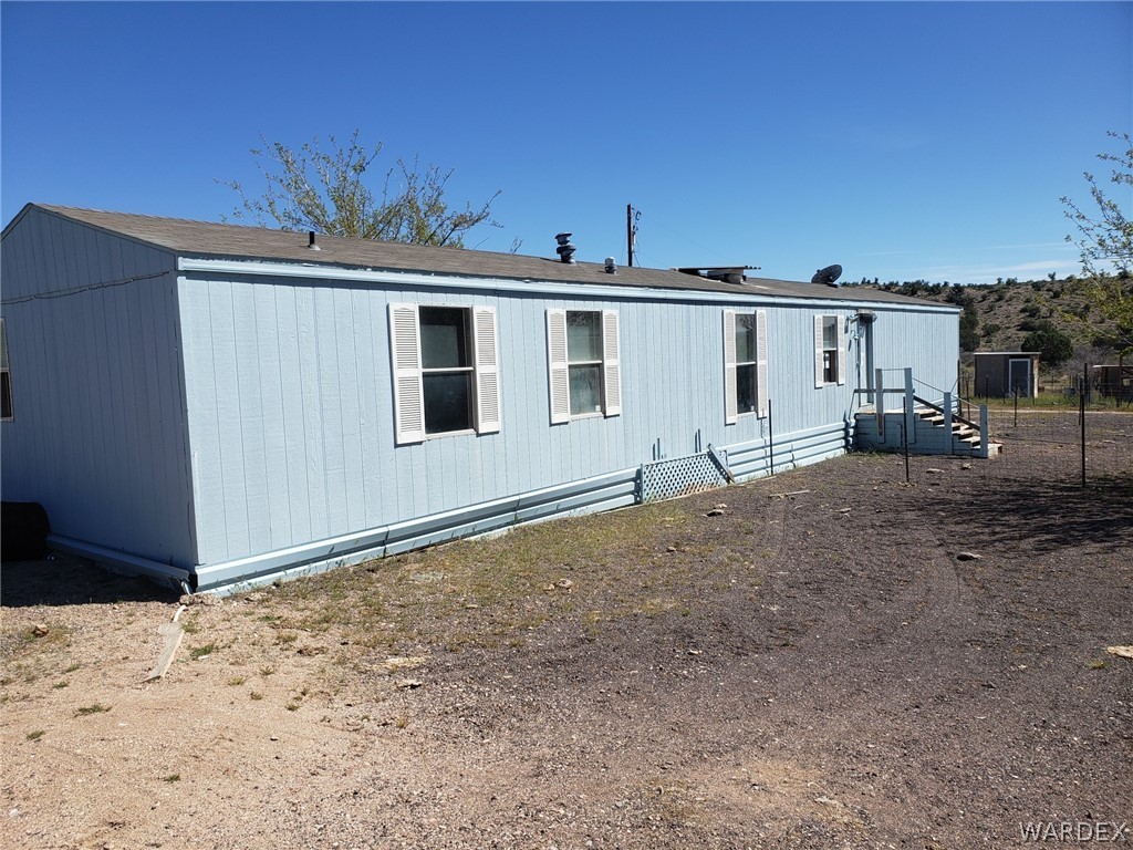 14185 Powerline Road Kingman, AZ 86401 - Photo 2 of 22 a view of a house with a backyard