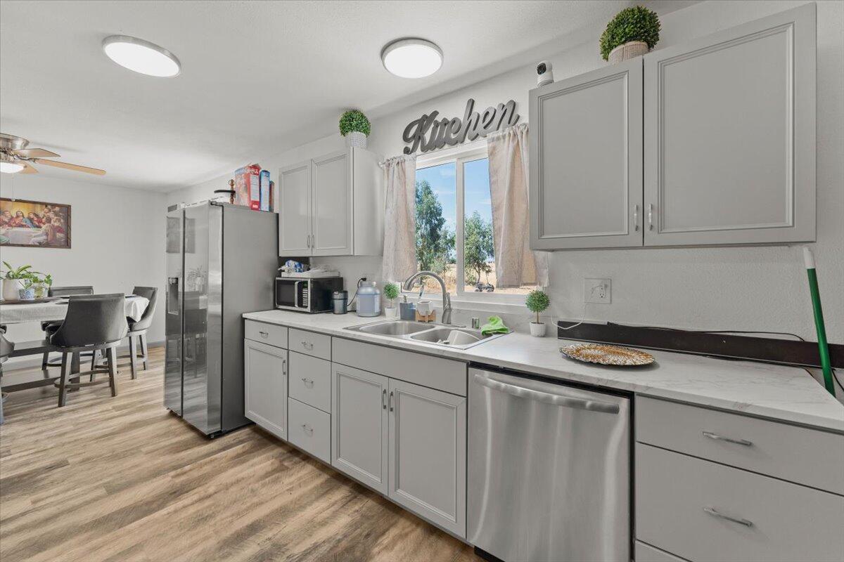 10755 Cody Drive Red Bluff, CA 96080 - Photo 14 of 77 a kitchen with stainless steel appliances a sink cabinets and wooden floor