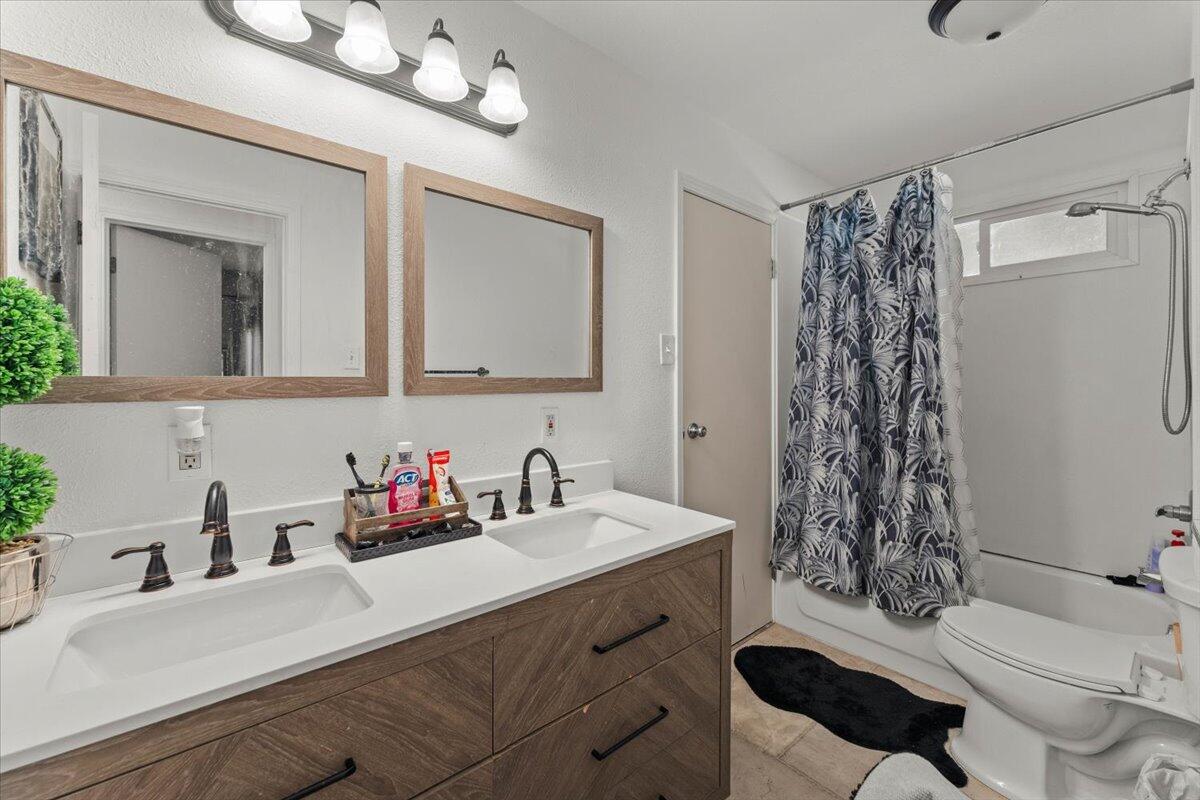 10755 Cody Drive Red Bluff, CA 96080 - Photo 29 of 77 a bathroom with a sink a toilet and shower curtain