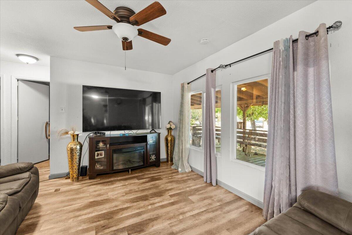 10755 Cody Drive Red Bluff, CA 96080 - Photo 6 of 77 a living room with furniture and a flat screen tv