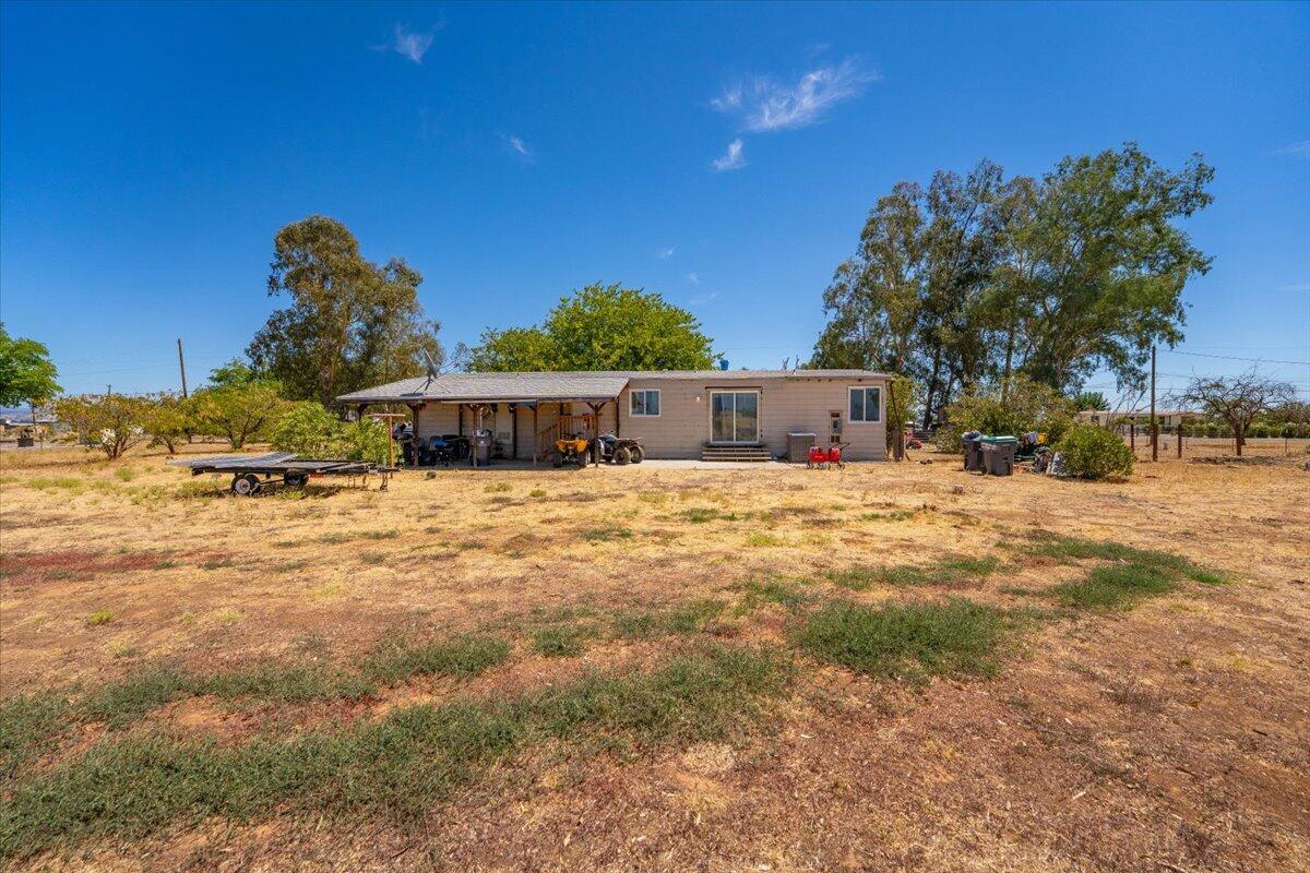 10755 Cody Drive Red Bluff, CA 96080 - Photo 76 of 77 a front view of a house with a yard covered with snow and trees
