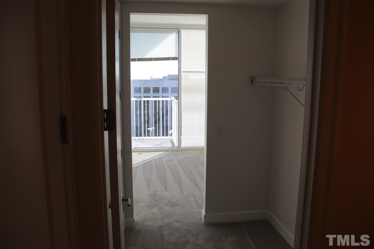 301 Fayetteville Street, Unit 2408 Raleigh, NC 27601 - Photo 11 of 19 The walk in closet provides great storage, access to the bathroom, and houses the stacked washer/dryer unit for super convenient laundry.