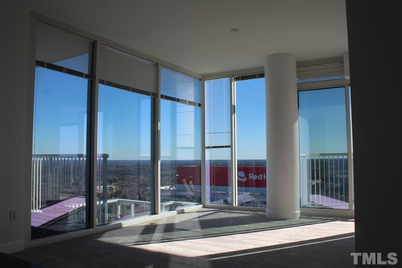 301 Fayetteville Street, Unit 2408 Raleigh, NC 27601 - Photo 4 of 19 Wall-to-wall windows provide unbelievable scenery from the comfort of this living room.