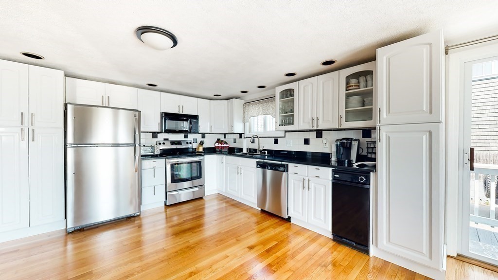 151 The Strand Winthrop, MA 02152 - Photo 12 of 36 a kitchen with stainless steel appliances a refrigerator sink and microwave