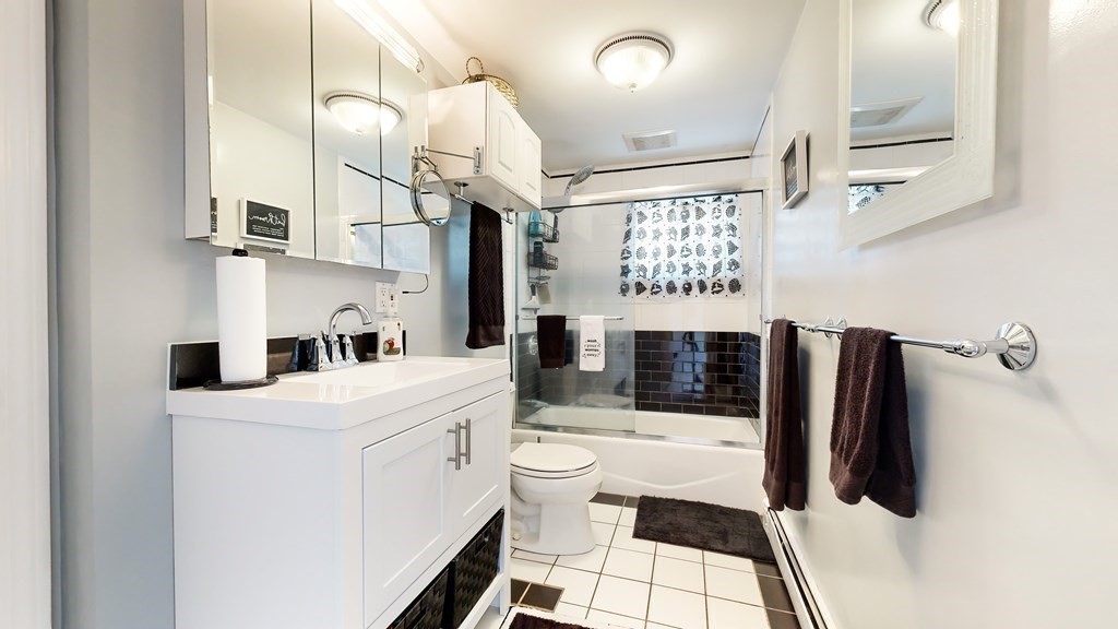 151 The Strand Winthrop, MA 02152 - Photo 13 of 36 a bathroom with a sink a toilet and shower