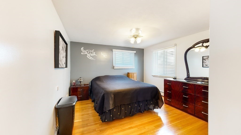151 The Strand Winthrop, MA 02152 - Photo 14 of 36 a bedroom with a bed and window