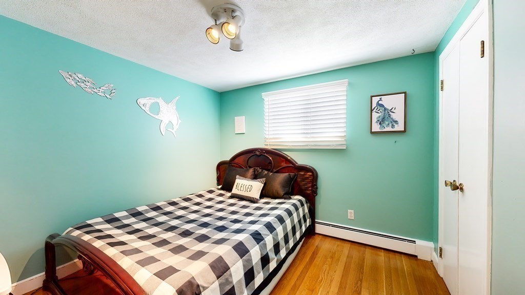 151 The Strand Winthrop, MA 02152 - Photo 16 of 36 a bedroom with a bed and a window