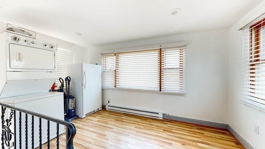 151 The Strand Winthrop, MA 02152 - Photo 17 of 36 a view of empty room with wooden floor and fan