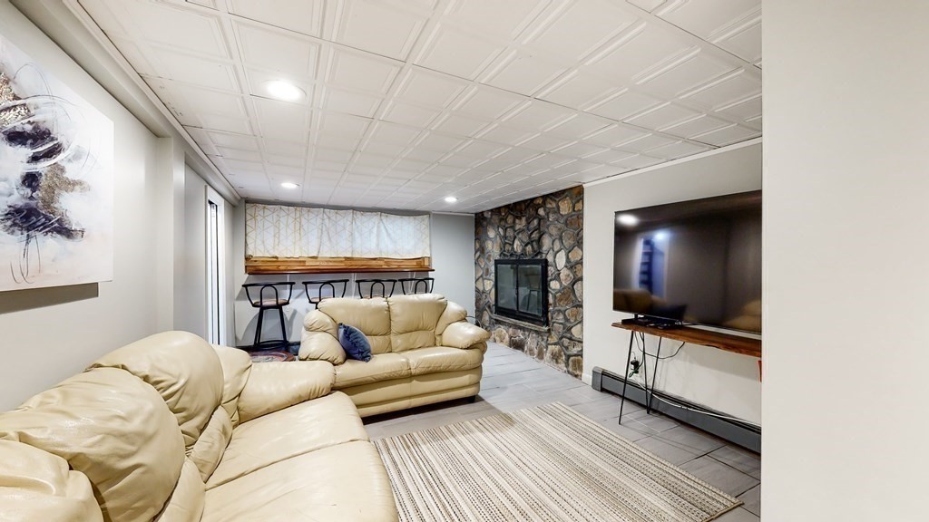 151 The Strand Winthrop, MA 02152 - Photo 20 of 36 a living room with furniture and a flat screen tv
