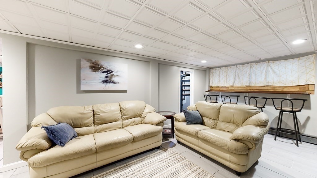 151 The Strand Winthrop, MA 02152 - Photo 22 of 36 a living room with furniture and a rug