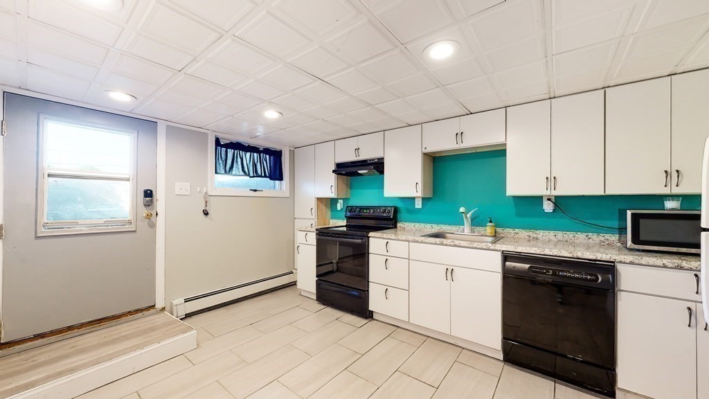 151 The Strand Winthrop, MA 02152 - Photo 24 of 36 a kitchen with a cabinets and white appliances