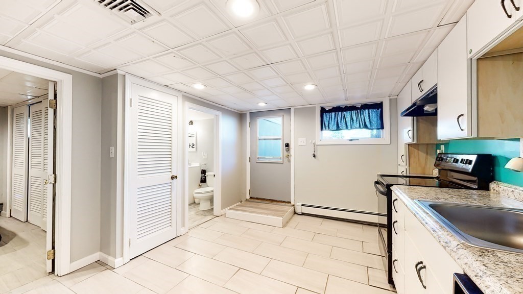 151 The Strand Winthrop, MA 02152 - Photo 25 of 36 a kitchen with stainless steel appliances granite countertop a refrigerator and a sink