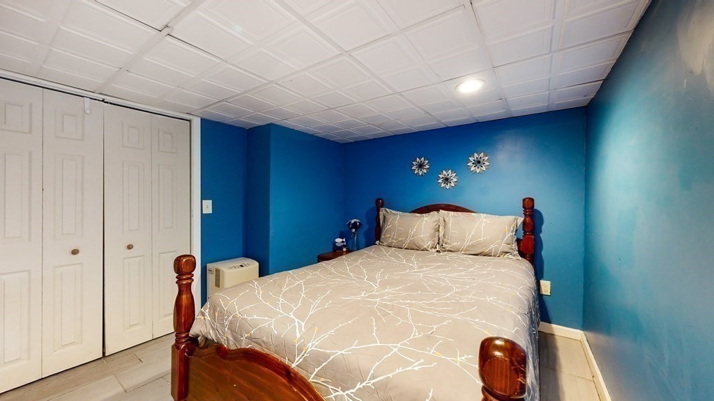 151 The Strand Winthrop, MA 02152 - Photo 29 of 36 a bed room with a bed and a lamp