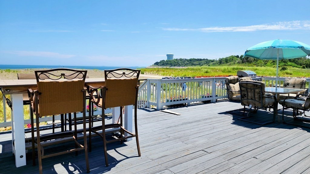 151 The Strand Winthrop, MA 02152 - Photo 6 of 36 a view of a balcony with chairs and wooden floor