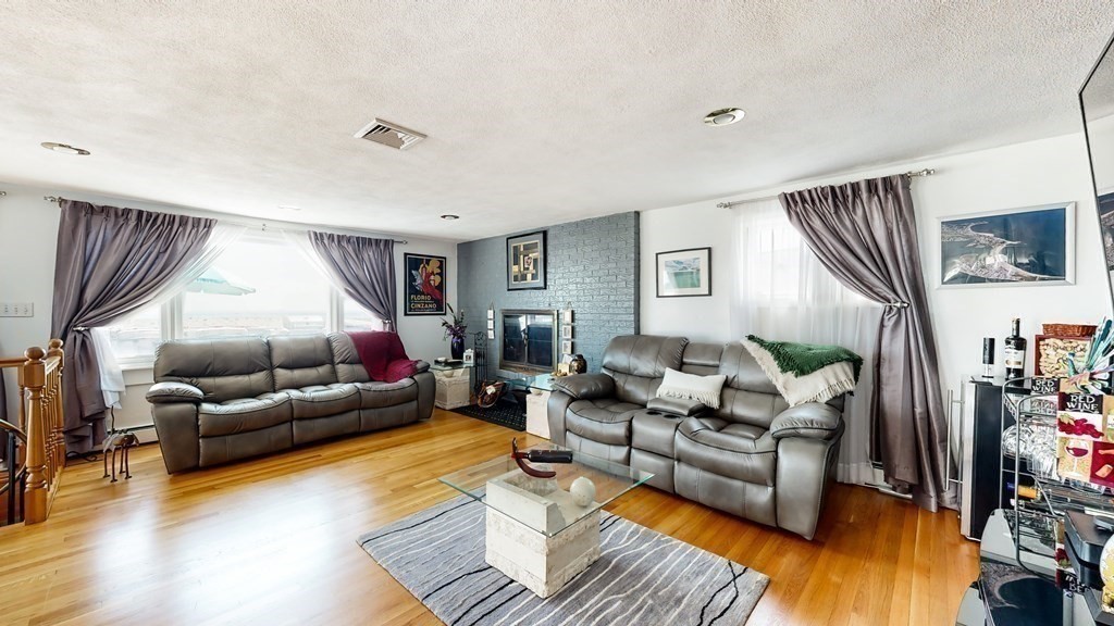 151 The Strand Winthrop, MA 02152 - Photo 8 of 36 a living room with furniture and a flat screen tv