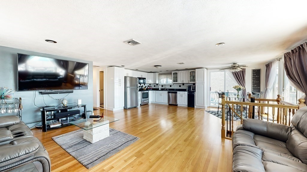 151 The Strand Winthrop, MA 02152 - Photo 9 of 36 a living room with furniture and a flat screen tv