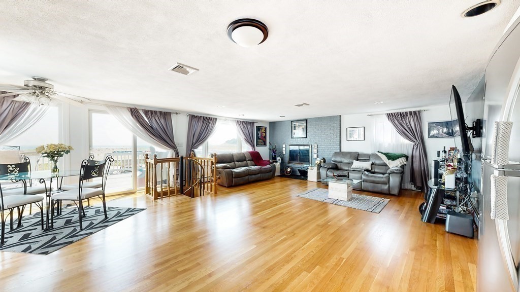151 The Strand Winthrop, MA 02152 - Photo 10 of 36 a living room with furniture and a wooden floor