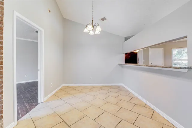 a view of wooden floor and chandelier in living room