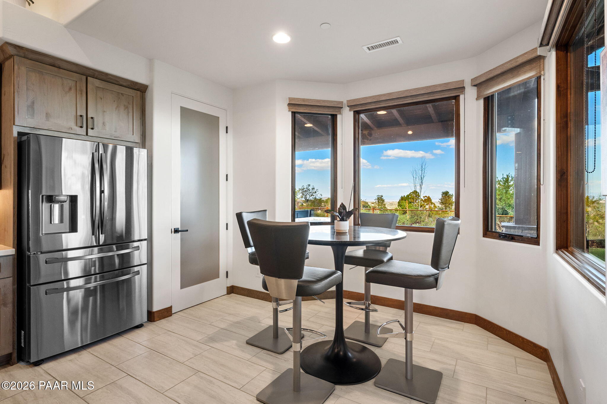 2140 Forest Mountain Road Prescott, AZ 86303 - Photo 16 of 56 a kitchen with stainless steel appliances a dining table chairs and a refrigerator