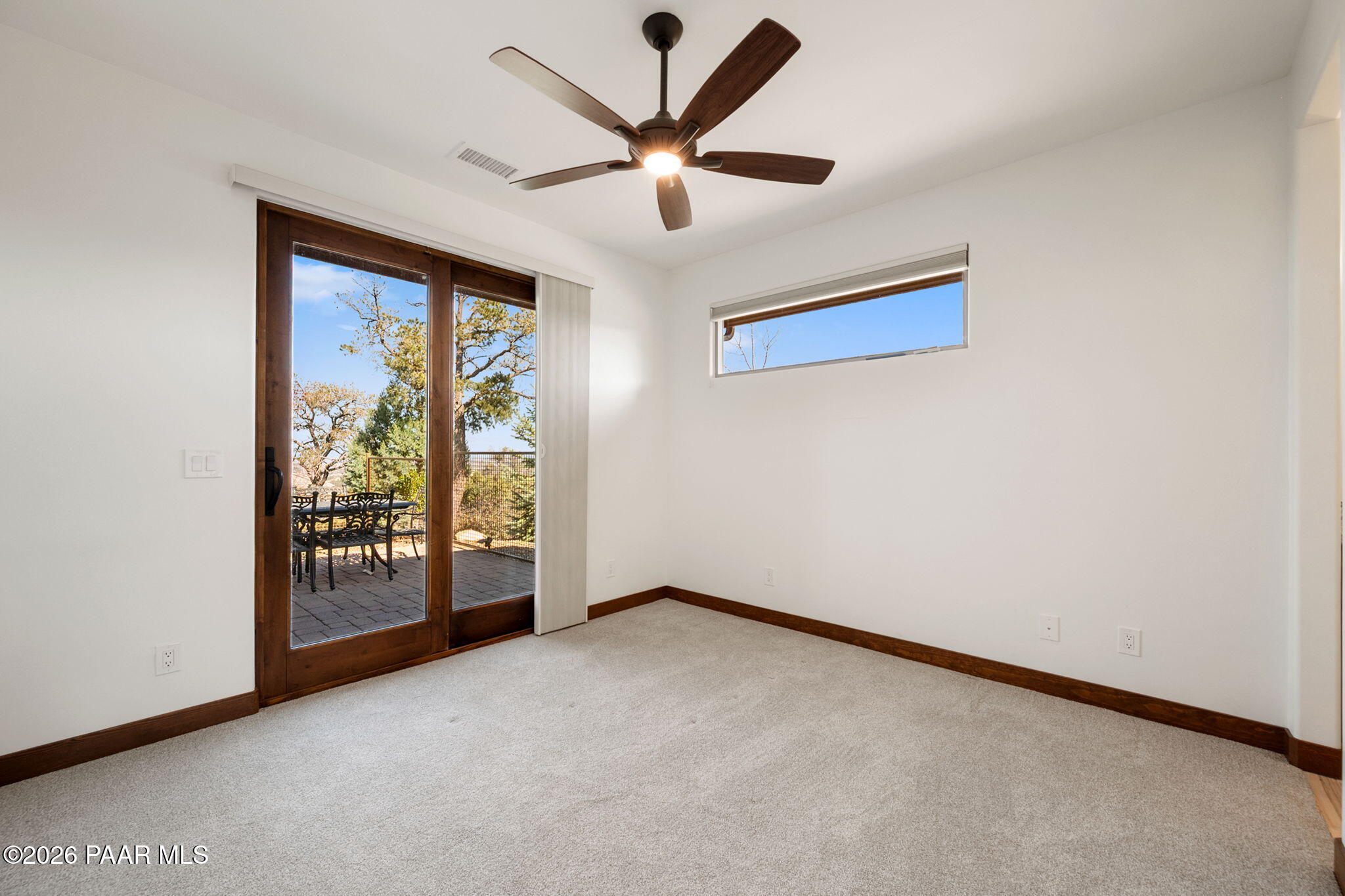 2140 Forest Mountain Road Prescott, AZ 86303 - Photo 31 of 56 an empty room with windows and ceiling fan