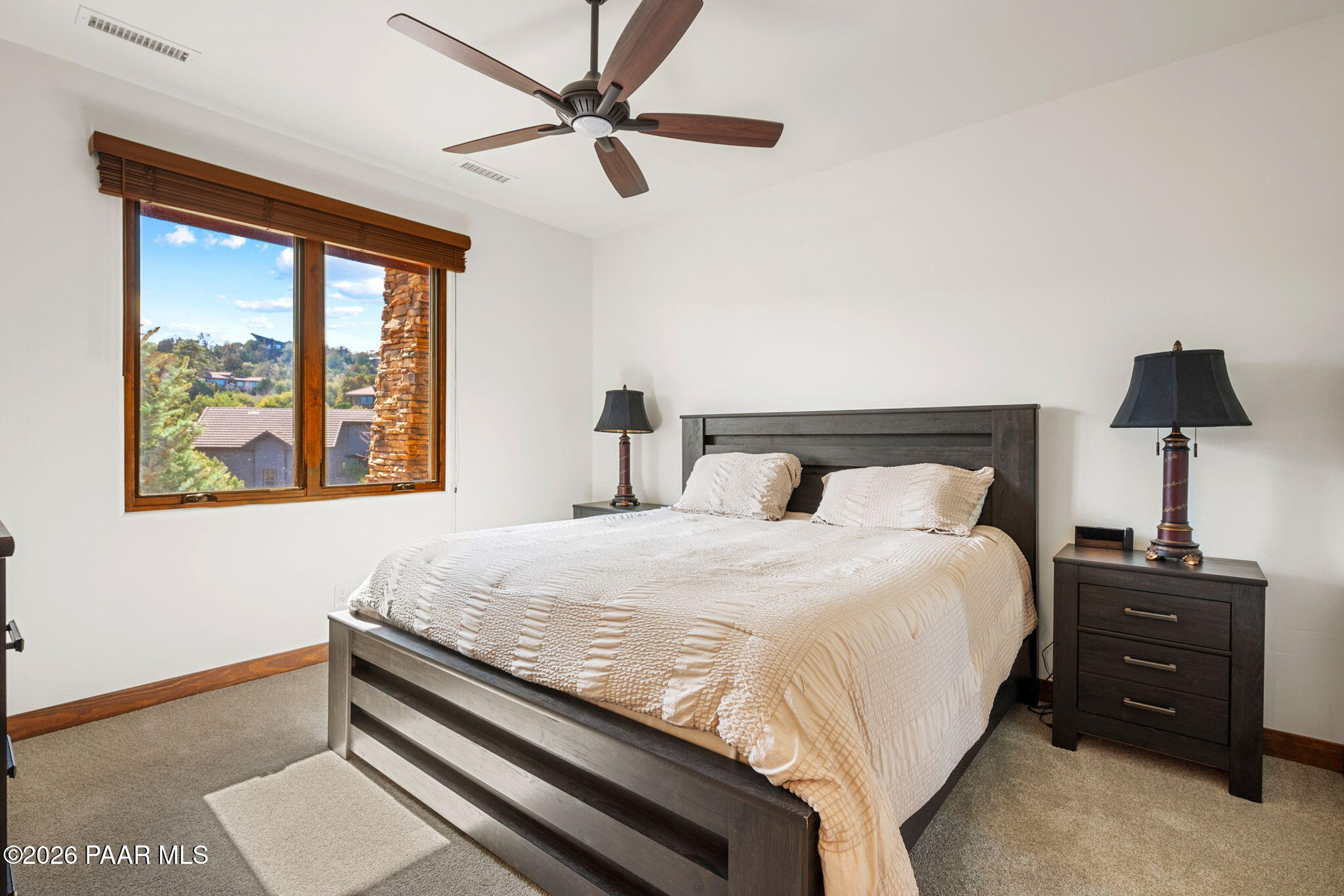2140 Forest Mountain Road Prescott, AZ 86303 - Photo 36 of 56 a bedroom with a bed and a lamp on dresser