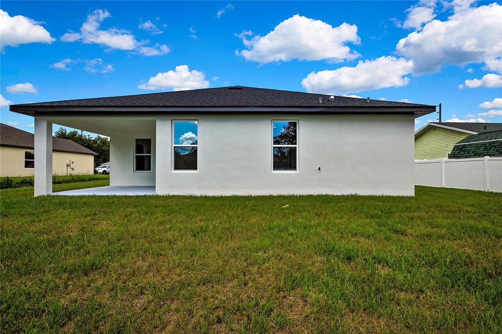 6589 Freeport Drive Spring Hill, FL 34608 - Photo 50 of 63 a view of a backyard with a large tree