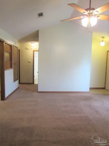 a view of an empty room with a fan