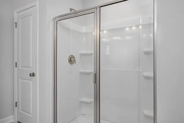 a bathroom with a glass shower door