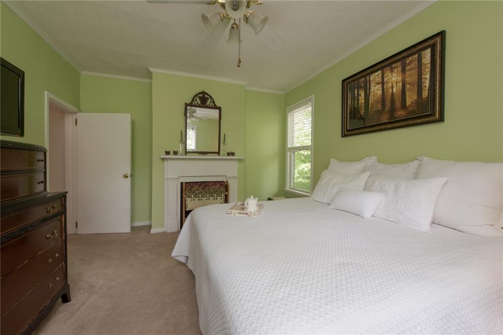 1 Quarry Road Sewickley, PA 15143 - Photo 12 of 25 A spacious master bedroom includes a decorative fireplace.