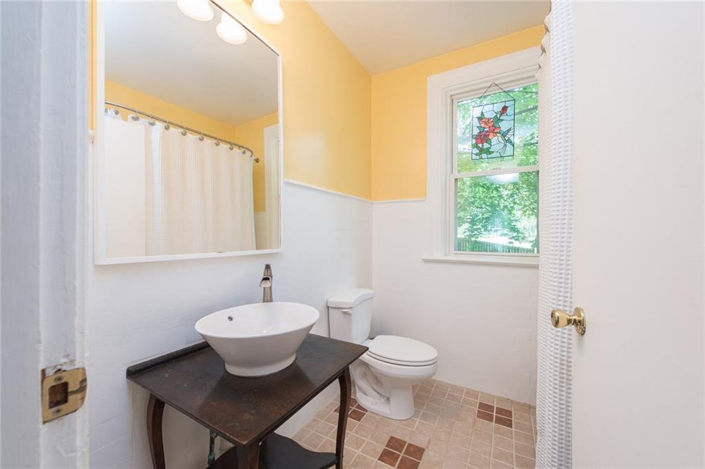 1 Quarry Road Sewickley, PA 15143 - Photo 16 of 25 The second full bathroom on the second level holds a vessel sink installed in an antique piece of furniture.