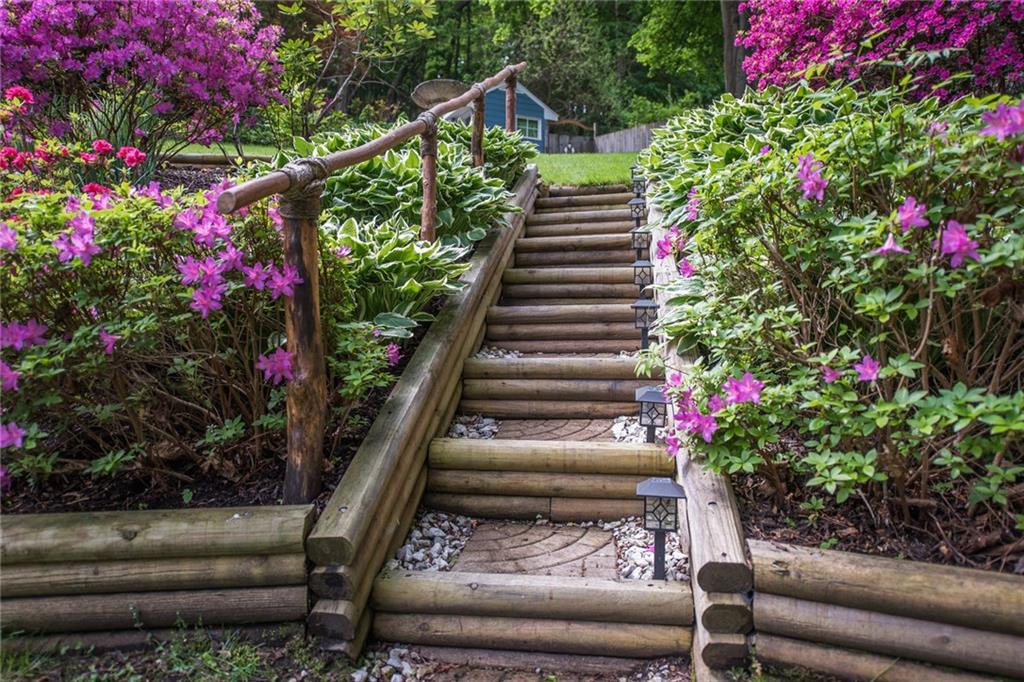 1 Quarry Road Sewickley, PA 15143 - Photo 20 of 25 Truly unique wooden staircase with railing leads up to the pool area.