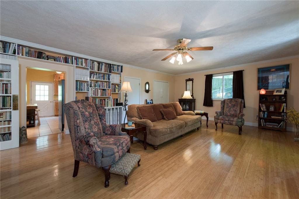 1 Quarry Road Sewickley, PA 15143 - Photo 6 of 25 The kitchen leads into the generous living room with built-in shelves.
