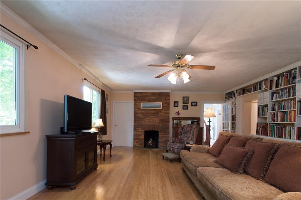 1 Quarry Road Sewickley, PA 15143 - Photo 7 of 25 A brick fireplace is a focal point in the living room.