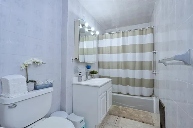 a bathroom with a sink a toilet a shower and mirror