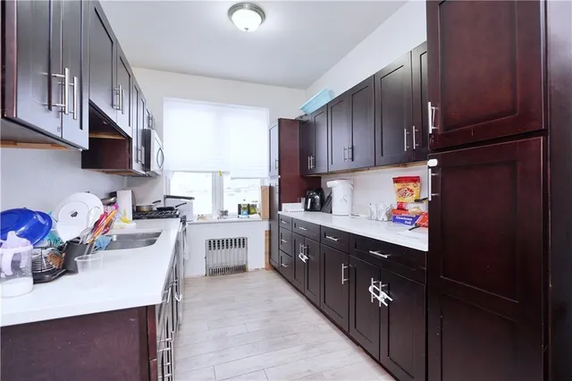 a kitchen with a sink a stove and cabinets