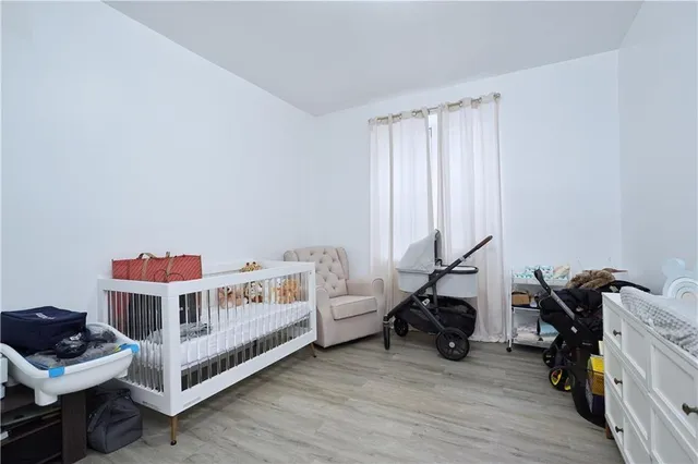 a bedroom with furniture and a baby crib