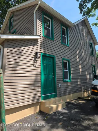 a view of a house with a yard and large window