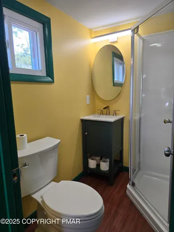 a bathroom with a toilet a sink and mirror
