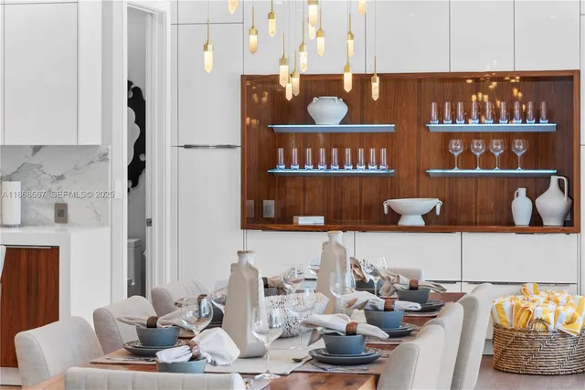 a living room with stainless steel appliances kitchen island granite countertop wooden floor a dining table and chairs