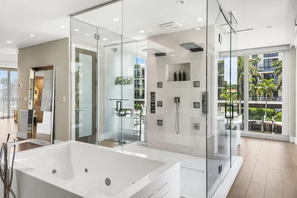 a bathroom with a tub shower vanity and sink