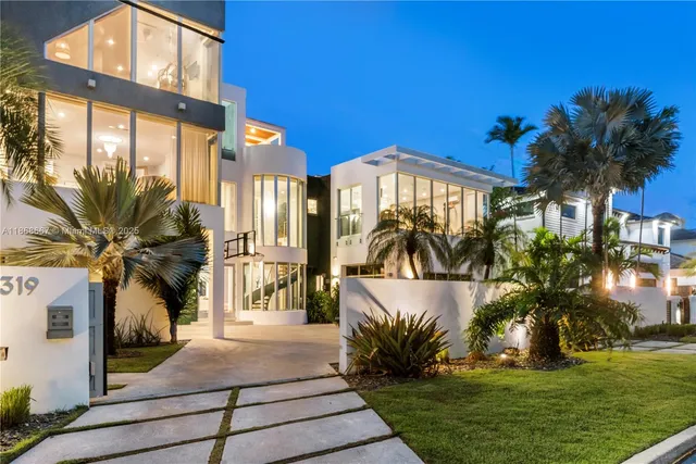 a kitchen with stainless steel appliances kitchen island granite countertop a table chairs microwave and sink