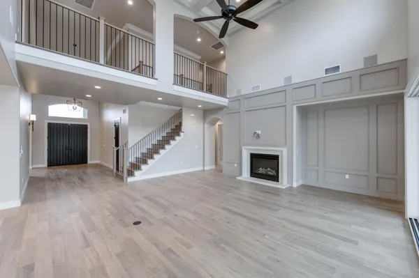a kitchen with stainless steel appliances granite countertop a sink dishwasher a stove and a refrigerator with wooden floor