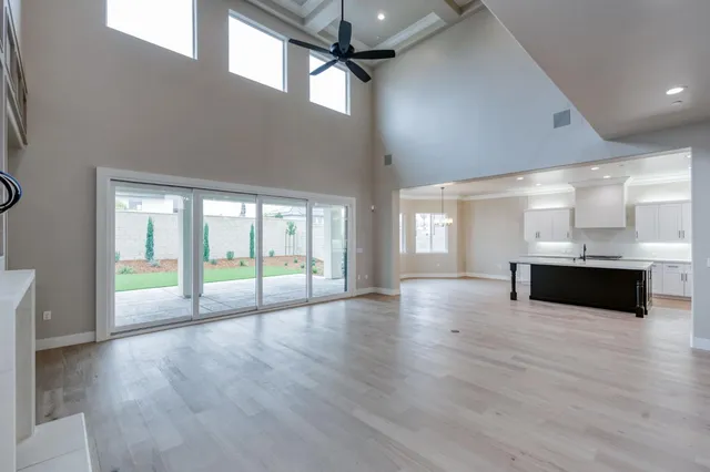 a large kitchen with stainless steel appliances lots of counter space and wooden floor
