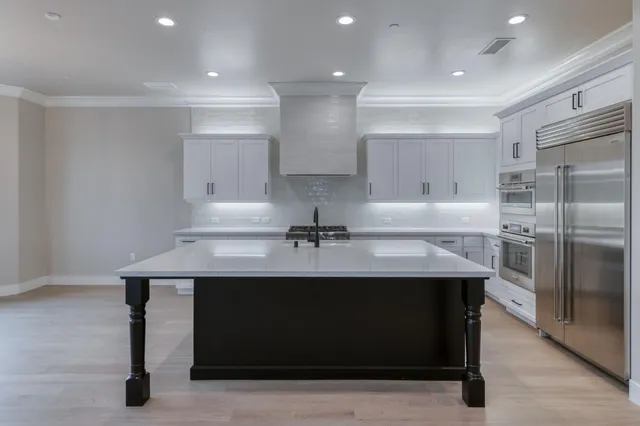 a kitchen with cabinets and stainless steel appliances