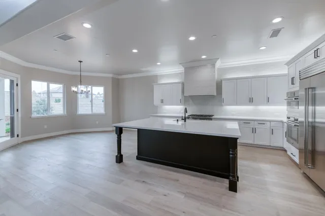 a kitchen with center island table and chairs