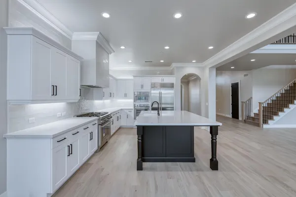 a view of a chandelier in big room and wooden floor
