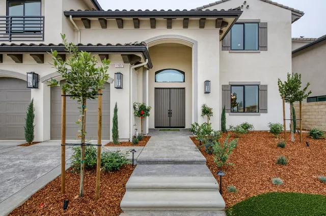 a kitchen with kitchen island granite countertop a sink and stainless steel appliances