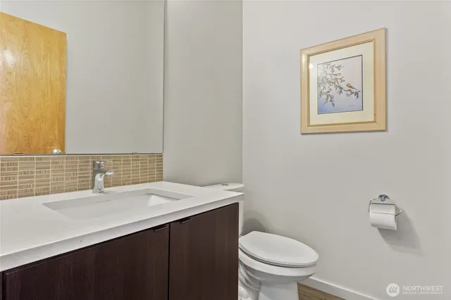 a bathroom with a sink a toilet and mirror
