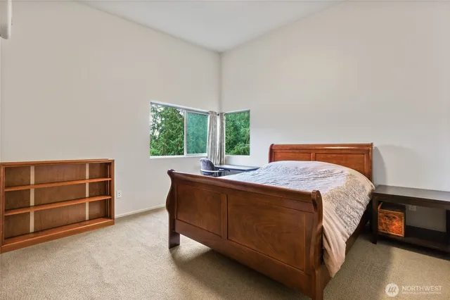 a bed sitting in a bedroom next to a window